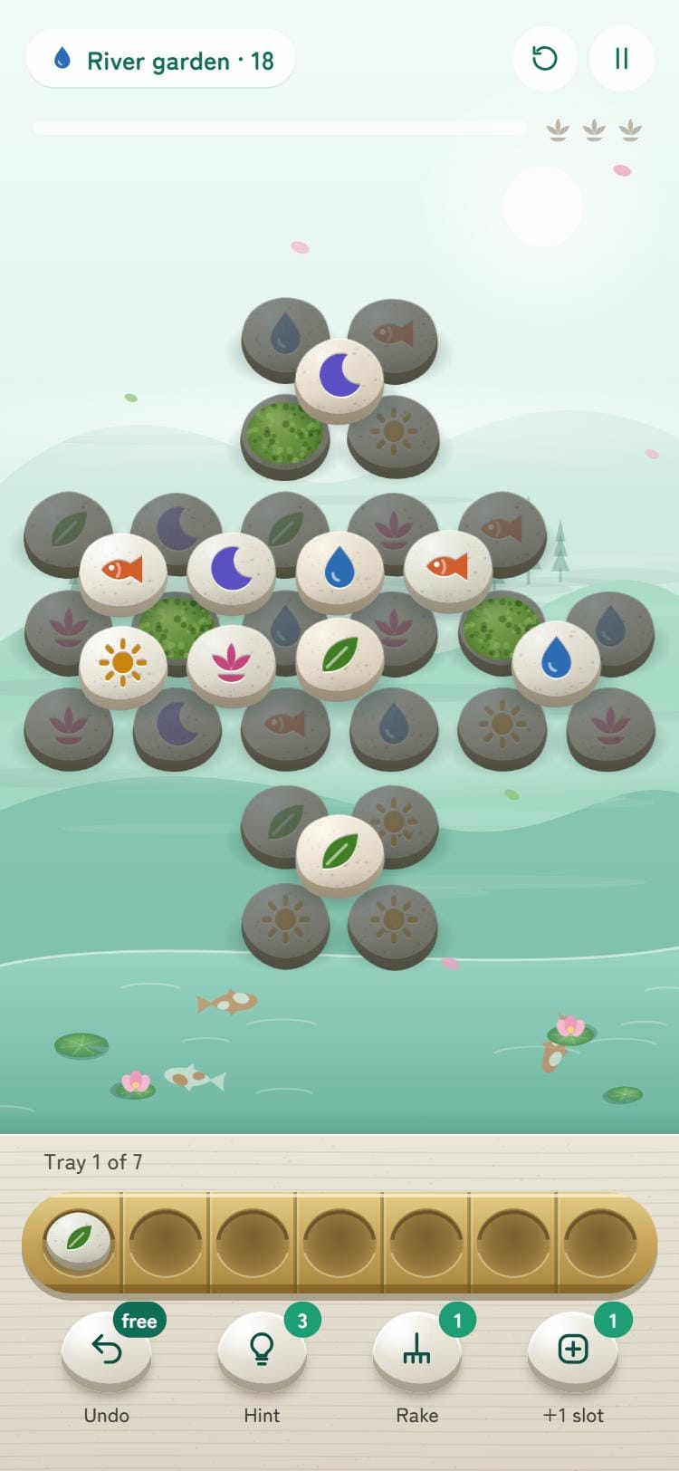 A garden in play, with river stones on the board and the bamboo tray below